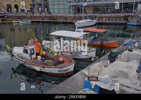Small fishing boats docked in Genoa harbour, Italy, May 2023 Stock Photo