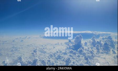 White storm cloud formations above the city from the airplane window for graphic resources PowerPoint slide template background Stock Photo