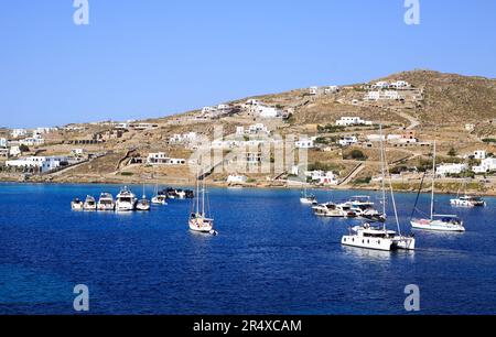 Ornos in Mykonos is a quaint coastal village and harbour with lots of small luxury boats moored. Stock Photo