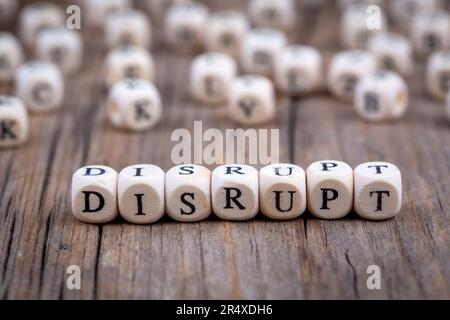 Word DISRUPT made with wood building blocks Stock Photo