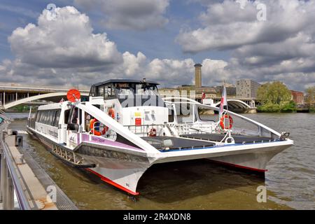 London Wandsworth Battersea blue sky over River Thames and Chelsea Bridge and Uber Boat thames clipper docking at the Coaling Jetty Stock Photo