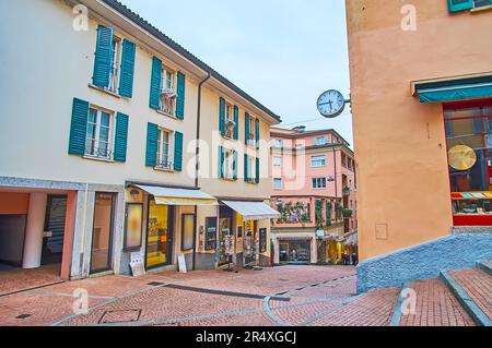 LUGANO, SWITZERLAND - MARCH 14, 2022: The corner of Via Cattedrale and Via Borghetto streets in old town with a view on small shops and colored histor Stock Photo