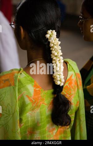 Woman with jasmine flowers in her hair at the Meenakshi Temple; Madurai, Tamil Nadu, India Stock Photo