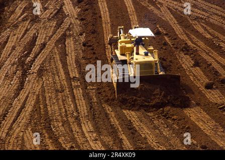 Elevated view of bulldozer and it's tracks on cleared land; United States of America Stock Photo