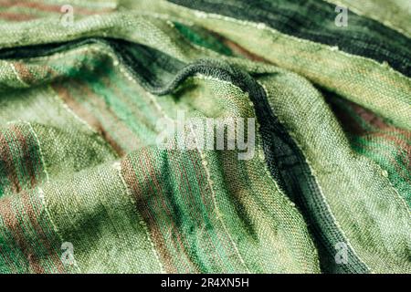 Green scarf fabric texture. Coarse twisted fabric, background. Stock Photo