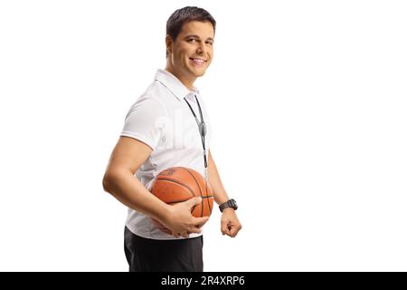 Basketball coach holding a ball and smiling isolated on white background Stock Photo