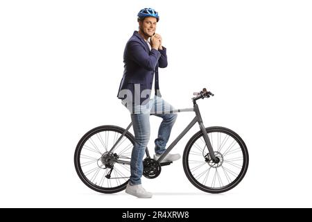 Man with a bicycle putting on a helmet isolated on white background Stock Photo