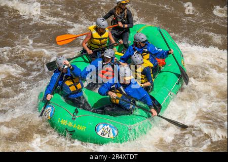 Truly adventure photograph of people taking on the rough water of the Arkansas River in spring of 2023 after lots of rain and snow melt made for some Stock Photo