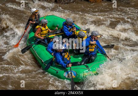 Truly adventure photograph of people taking on the rough water of the Arkansas River in spring of 2023 after lots of rain and snow melt made for some Stock Photo