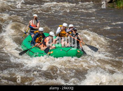 Truly adventure photograph of people taking on the rough water of the Arkansas River in spring of 2023 after lots of rain and snow melt made for some Stock Photo