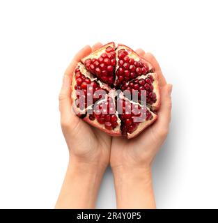 Ripe peeled pomegranate in hands on a white background top view. A whole pomegranate with a cut peel in the palms on the isolation. Healthy fruits. Stock Photo