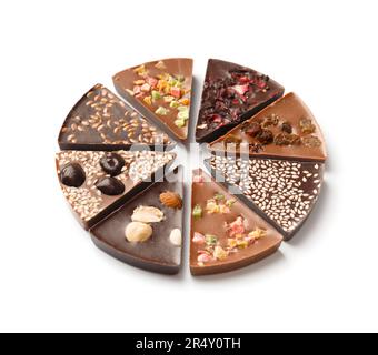 Chocolate pizza made of black and milk chocolate with candied fruits, nuts, raisins on a white background top view. Chocolate dessert Stock Photo