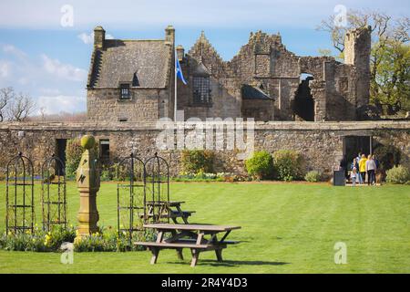 Aberdour, UK - April 21 2023: A family visits the historic, medieval heritage site of the 13th century Aberdour Castle and Gardens on a sunny Spring d Stock Photo