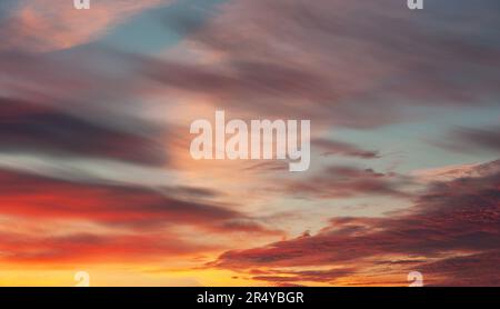 Real amazing panoramic sunset or sunrise sky with colorful clouds. Stock Photo