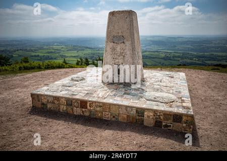 An Ordnance Survey monument or triangulation pillar at the summit of The Wrekin, a hill in Shropshire, England. Stock Photo