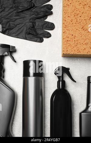Flat lay composition with car cleaning products on light grey marble ...