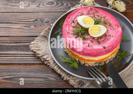 Herring under fur coat salad served on wooden table, space for text. Traditional Russian dish Stock Photo