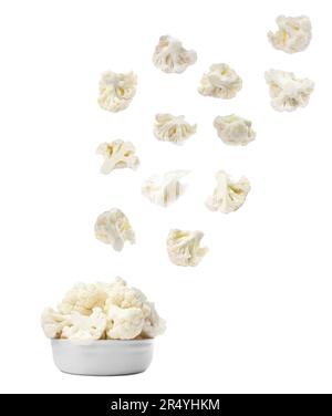 Many fresh cauliflower florets falling into bowl on white background Stock Photo