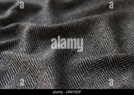 Crumpled black herringbone suit fabric for sale in store Stock Photo