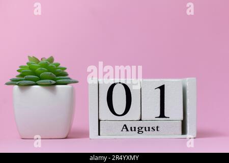 August 1 in the calendar on a pink background is the start date of a new month Stock Photo