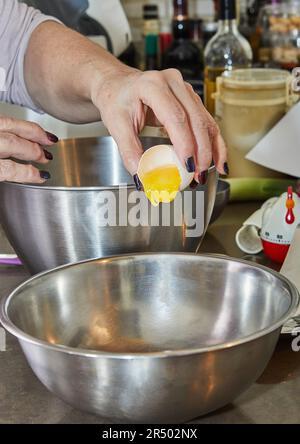 Chef beats in the yolk and white to make the cake Stock Photo