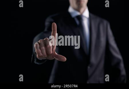 Business man pressing an imaginary button at his office. Stock Photo