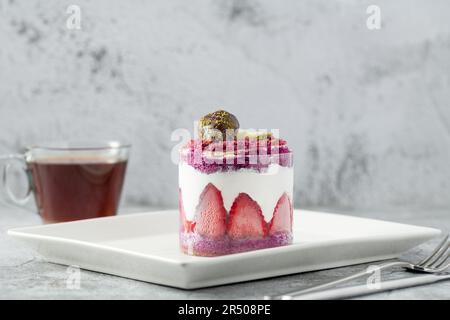 Strawberry shortcake with tea on a white porcelain plate Stock Photo