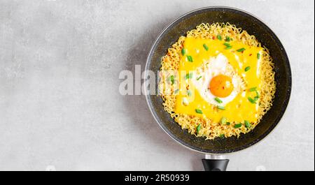 Kujirai Ramen, Shin Ramyeon or Ramyun with Egg, Melted Cheese and Scallion, Instant Noodles on Bright Background Stock Photo