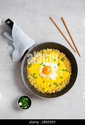 Kujirai Ramen, Shin Ramyeon or Ramyun with Egg, Melted Cheese and Scallion, Instant Noodles on Bright Background Stock Photo