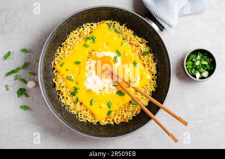 Kujirai Ramen, Shin Ramyeon or Ramyun with Egg, Melted Cheese and Scallion, Instant Noodles on Bright Background Stock Photo