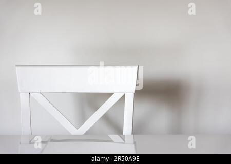 Minimalistic background with a white chair at the table in the kitchen. Stock Photo