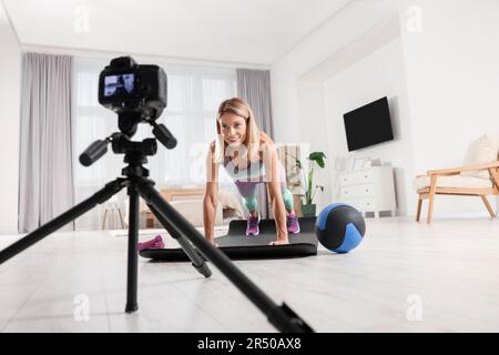 Fitness trainer recording online classes at home Stock Photo