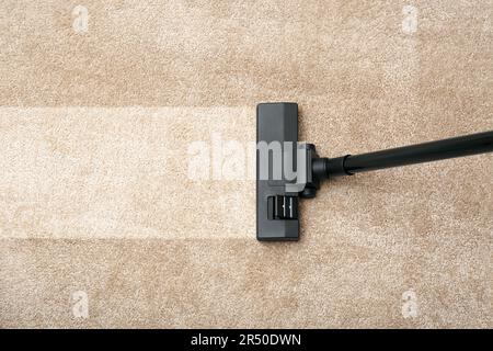 Vacuuming carpet. Clean area after using device Stock Photo
