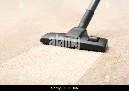 Vacuuming carpet. Clean area after using device, closeup Stock Photo