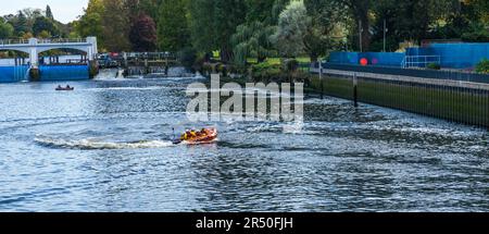 RNLI lifeboat crew on a training exercise in a dinghy at Teddington Lock,England,UK Stock Photo