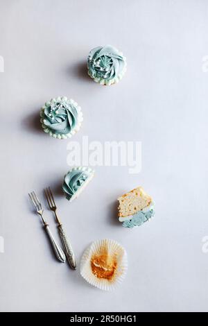 Whole and half cupcake with blue frosting Stock Photo