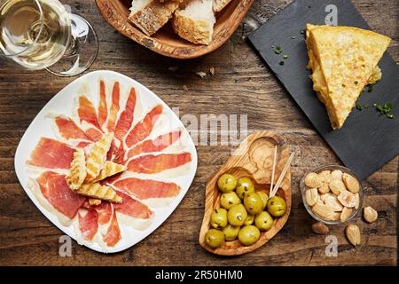 On Top Table Top view of Spanish tapas spread: croquettes with sprouts, spiced ...