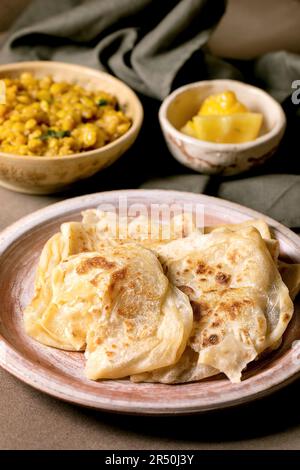 Traditional indian roti flatbread with yellow pea dhal Stock Photo