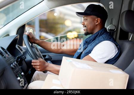Delivery man, transport and man driving with a smile for shipping or courier service. Happy black person or driver with cardboard box, package or Stock Photo