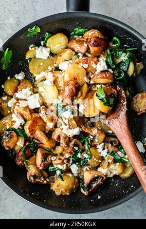 Simple potato and mushroom with feta and spinach cooked in a pan Stock ...