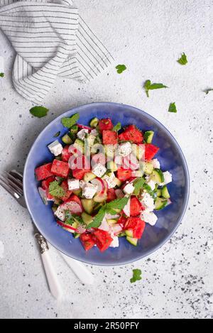 Salad with feta cheese, watermelon, cucumber, radish, and mint Stock Photo