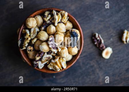 Mixed nuts in wooden bowl Stock Photo