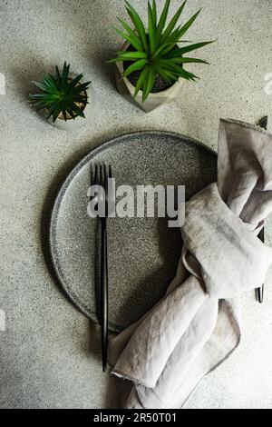 Minimalistic table setting cactus plants in the pot on concrete background Stock Photo