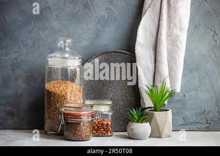 Raw food ingredients on the modern kitchen table with cactus plants in the cement pots Stock Photo
