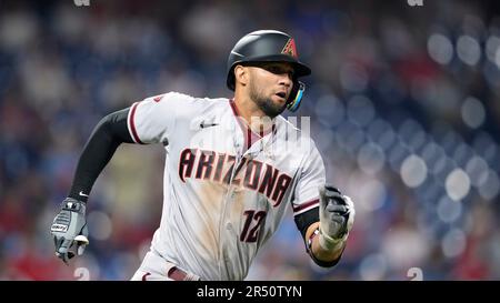 Arizona Diamondbacks left fielder Lourdes Gurriel Jr. (12) throws the ball  to Diamondbacks shortstop Geraldo Perdomo, left, after making a catch on a  fly ball hit by Seattle Mariners' Cal Raleigh during