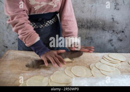 Bread dough being rolled out at a market in Cambodia Stock Photo