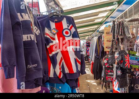 Souvenirs on sale in a souvenir in Windsor, UK including a jumper with a Union Jack design Stock Photo