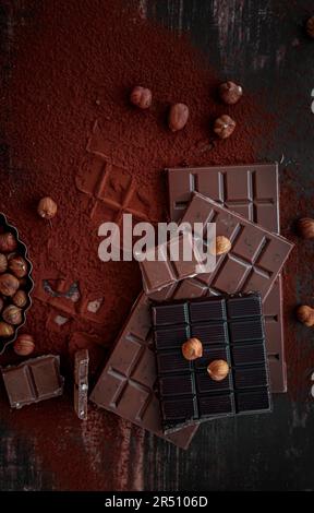 Assorted chocolate bars on cocoa powder Stock Photo