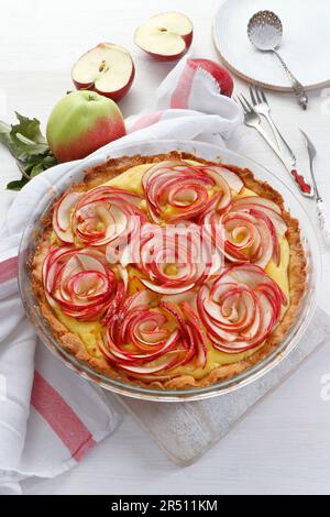 Tart on shortcrust pastry with apple slices arranged in flowers Stock Photo