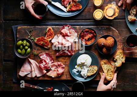 Cold cuts platter with burrata, olives and mini arancini Stock Photo
